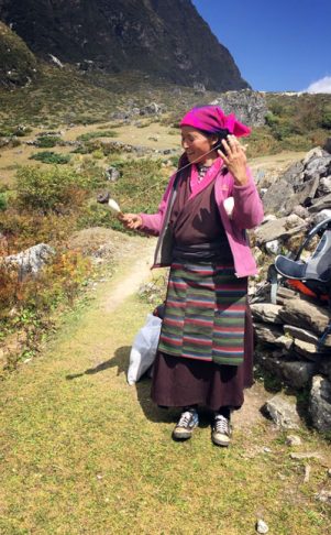 Tibetan woman spinning as she walks between villages along our route | The Physician Assistant Life Tibetan woman spinning as she walks between villages along our route