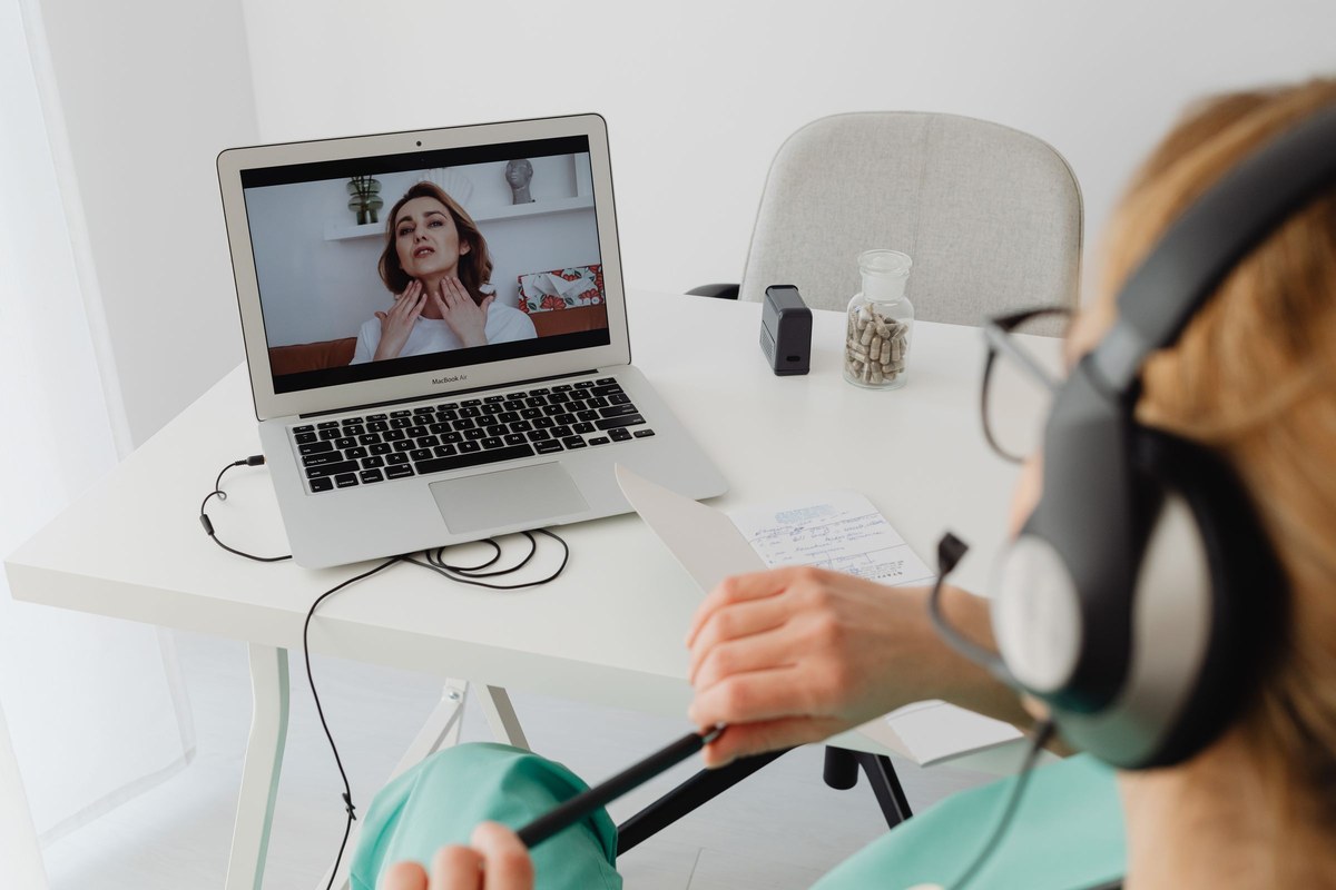 aiclinicalconsultationstock | The Physician Assistant Life A healthcare professional conducts a remote consultation by laptop